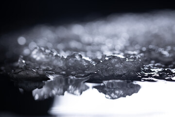 Snow close-up on a dark background. melting ice. 