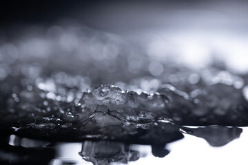 Snow and ice close-up on a dark background. Abstract winter background.