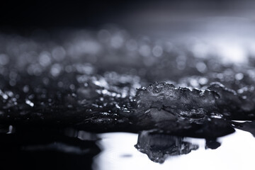 Snow and ice close-up on a dark background. Abstract winter background.