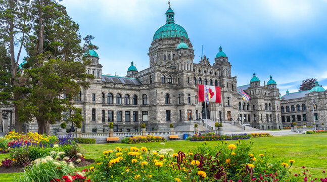 Parliament buildings and flower gardens shining in victoria, british columbia