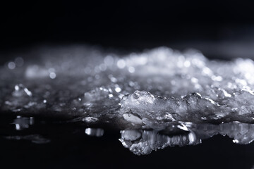Snow and ice close-up on a dark background. Abstract winter background.