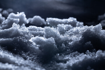 Snow close-up on a dark background. melting ice. 