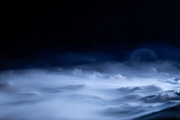 Snow and ice close-up on a dark background. Abstract winter background.