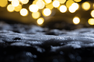 Close-up of snow and ice against a bokeh background. Abstract New Year's background.