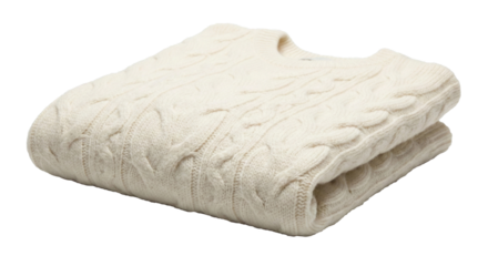 A neatly folded cream cable knit sweater, transparent background