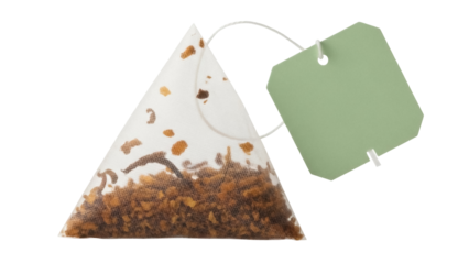 Triangular tea bag with green label isolated PNG on transparent background, herbal infusion for a relaxing and healthy beverage