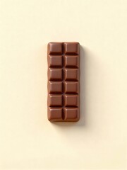 Obraz premium Delicious chocolate bar on cream background, sweet treat