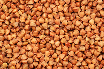 Hulled roasted buckwheat cereal kernels close-up. Food background.