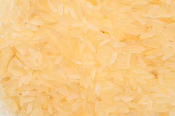Pile of parboiled rice close up. Food background.