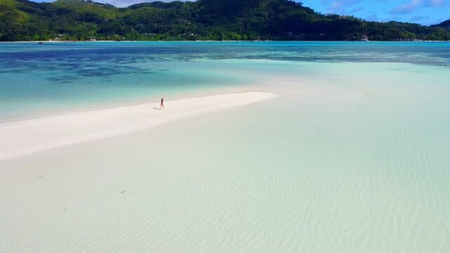 Tranquil walk on a tropical Seychelles beach in summer