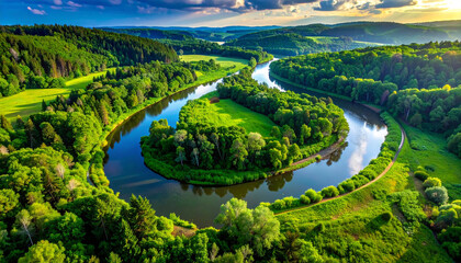 An aerial view of a tranquil forest lake with its water surface reflecting light