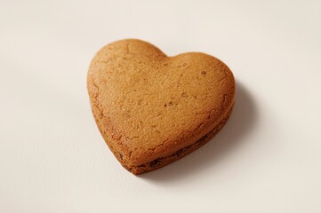 Heart shaped gingerbread cookie on plain background