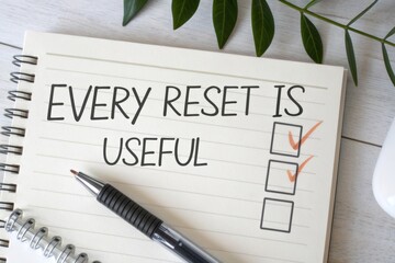 Notebook checklist with 'Every Reset Is Useful' message and checked tasks beside a pen