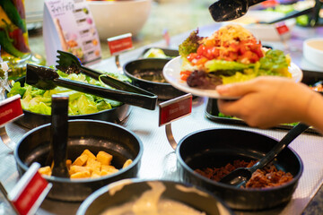 Various vegetable and fruit salad in salad bar shop