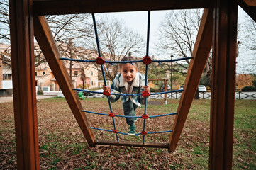 Child playing on climbing structure in park