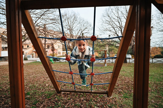 Child playing on climbing structure in park