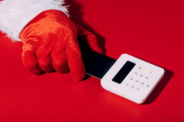 Santa hand using card for Christmas shopping payment
