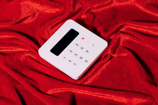 Payment terminal on red fabric background for christmas