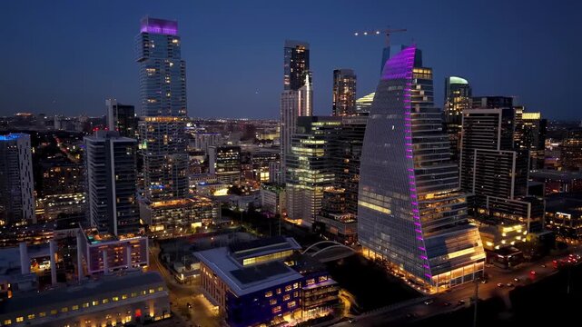 Nightscape of Austin's downtown with glowing skyscrapers, city lights, and river reflections. Urban and cityscape concepts