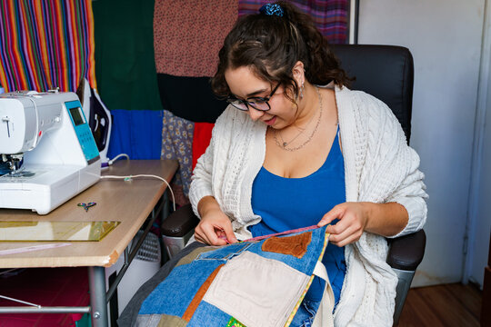 Chilean seamstress working on a colorful fabric piece