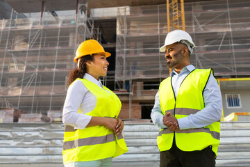Construction team discussing project progress on site