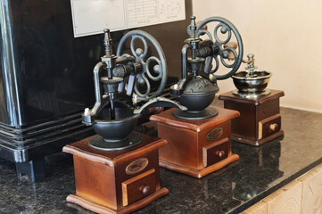 Traditional coffee grinders are used as decorative elements in cafes.