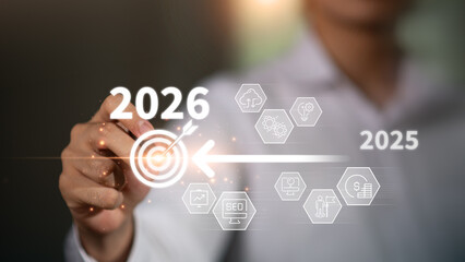 Businessman pointing to digital target icon with transition from 2025 to 2026, symbolizing business growth, future vision, goal setting, strategic planning for the upcoming year, visionary content.