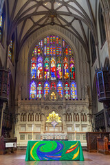 Trinity Church interior highlighting colorful stained glass altar