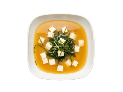 Isolated square bowl of traditional Japanese miso soup with tofu, seaweed, and broth