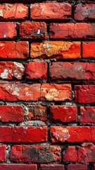 Close-up of weathered red brick wall, showing texture and decay