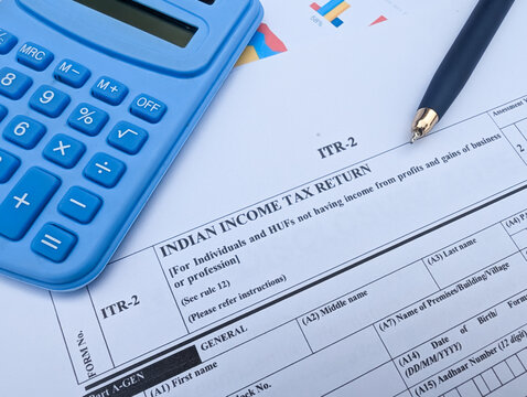 Indian Income Tax Return ITR-2 form with blue calculator and pen