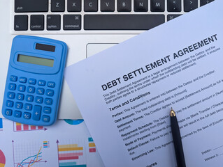 debt settlement agreement paper with pen