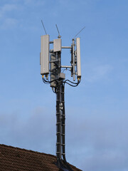 Obraz premium Telecommunications or radio tower against a blue sky