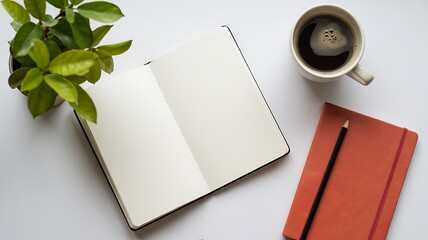 Overhead view of a desk with an open notebook, coffee cup, red notebook, and a pencil, perfect for planning or journaling.