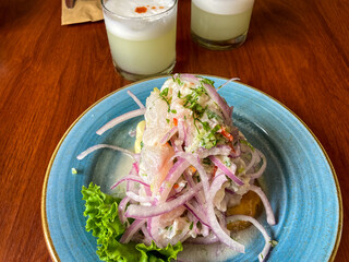 Traditional Peruvian ceviche with pisco sour in a Lima restaurant