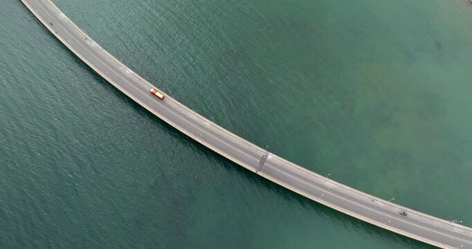 Aerial close-up of a long bridge over the sea. It is located in Augusta, in the province of Syracuse, Sicily, Italy. Connection concept.