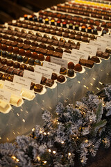 Belgian chocolate pralines displayed in shop window with festive Christmas decoration in Bruges, Belgium