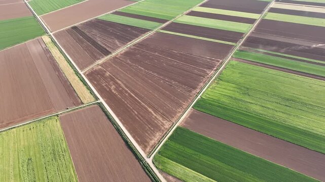 Aerial drone view of fertile agricultural fields and cultivated farmland patterns