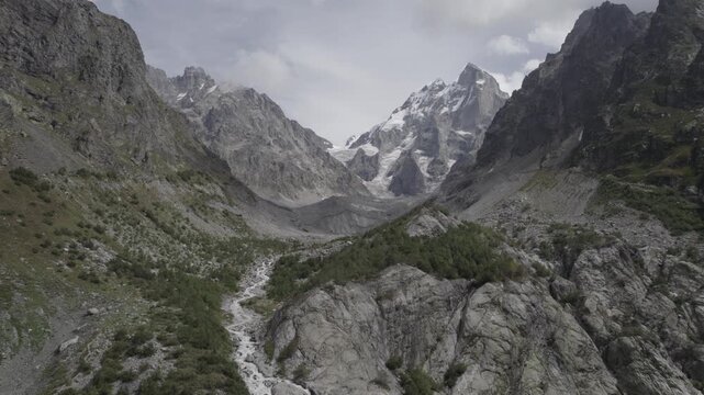 Aerial panorama of Shdugra Waterfall in the Dolra River valley, surrounded by the high Caucasus mountains in Svaneti, Georgia