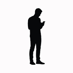 Man silhouette using mobile phone while standing