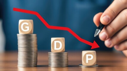 GDP decline shown with wooden blocks and coins on desk