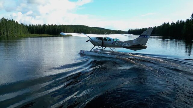 Floatplane boating on secluded lake amid dense forest and morning mist, smooth gliding in serene wilderness