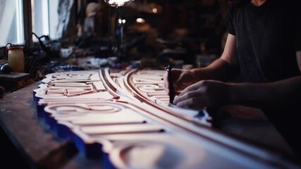 Custom plastic 3D printed signs being painted and assembled in an artisan workshop revealing handson craftsmanship and detail. - Powered by Adobe