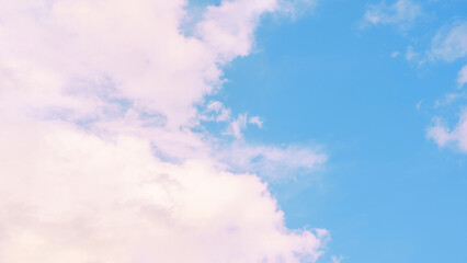 A beautiful sky with fluffy clouds in soft shades of pink and blue