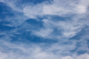 Wispy White Clouds in a Blue Sky. Blue Cloudy Sky. Nature and Climate Concept. Realistic...