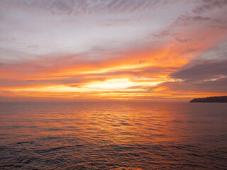 Dramatic Orange Sunset Over Calm Sea with Reflective Water. Peaceful Seascape Background for Travel, Meditation, Nature, Relaxation and Atmospheric Design