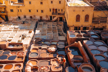 Tanner works in ancient dye pits, processing hides using traditional methods. Fes, Morocco