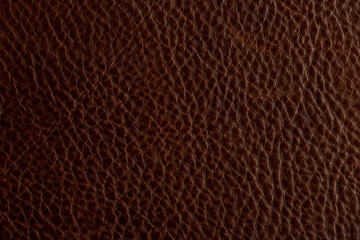 Texture of dark brown leather shows fine details and depth in natural grain pattern