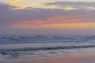Soft waves under pastel sunset sky