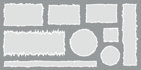 A set of torn paper pieces in different shapes and sizes on a gray background